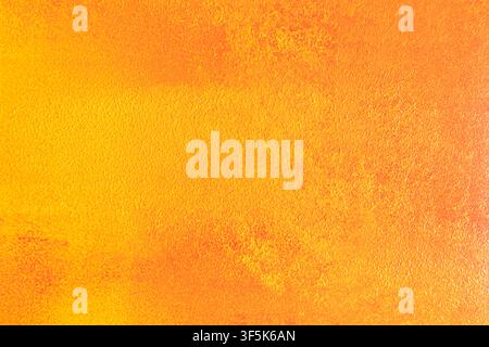 Bright abstract background with a warm orange and yellow textured surface, subtle grain, and soft color variation. Ideal for autumn design, art layout Stock Photo