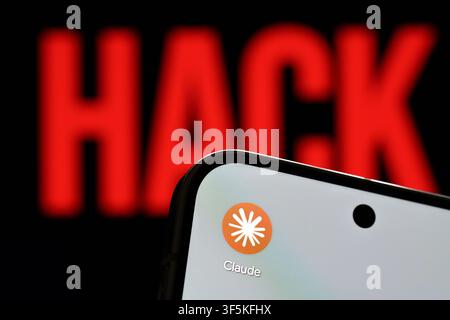 Claude app logo shown on a smartphone against a red HACK warning in an artificial intelligence cybersecurity concept. Stafford, United Kingdom, August Stock Photo