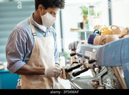 COVID-19 pandemic and small business, barista work during social distancing Stock Photo