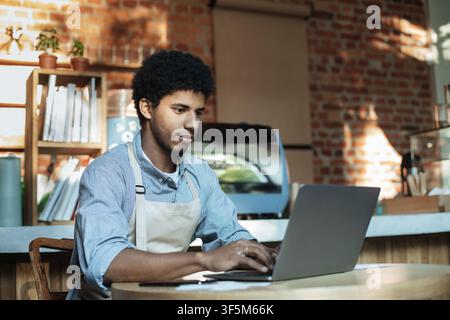 Man owner working and checking email on computer Stock Photo