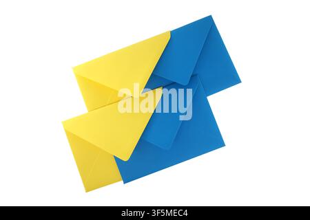 Bright blue and yellow envelopes layered on a white background representing mail, letters, correspondence and communication. Composition with bold col Stock Photo