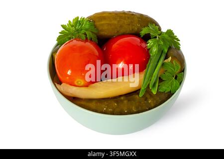 Pickled tomatoes and cucumbers in a bowl on a white background. Homemade canned vegetables Stock Photo