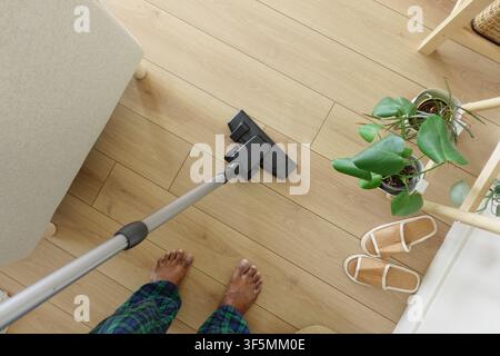 Cleaning floor with vacuum in living room at home Stock Photo
