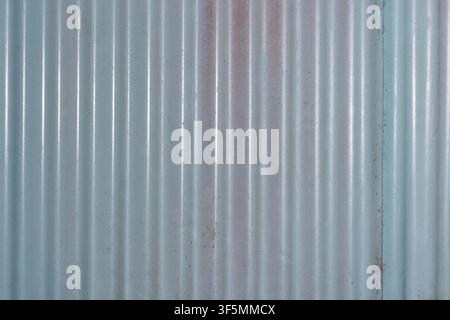 Vertical corrugated metal sheet texture background showing weathered ridged steel panel for industrial architecture design. High Quality Photo Stock Photo