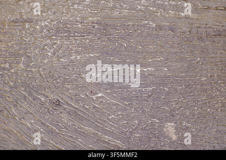 Detailed close-up shot of an abstract gold and bronze metallic textured surface with thick paint lines and liquid wave patterns for artistic background design. High Quality Photo Stock Photo