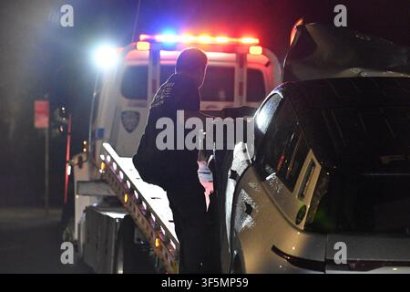 NYPD officers work the scene where a 31-year-old woman is in critical condition after she was struck by a 39-year-old man driving a 2003 Gray Fisker at Park Avenue and Nostrand Avenue within the confines of the 79 precinct in Brooklyn, New York, United States on Sunday, August 2, 2026. Sunday evening at approximately 9:11 pm, police responded and upon arrival it was determined that a 39-year-old man operating a 2003 Gray Fisker was traveling westbound on Park Avenue and attempting to turn onto Nostrand Avenue when he collided with a grey Honda minivan. The 2003 Gray Fisker then jumped the curb Stock Photo