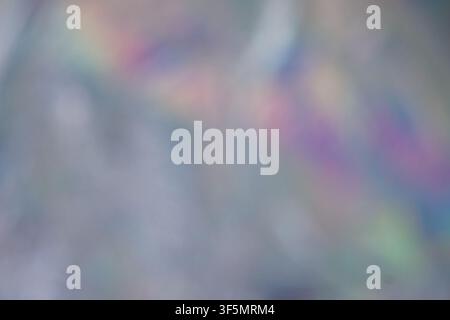 Soft out-of-focus abstract background featuring iridescent light leaks and prism rainbow colors. Useful for creative overlays and backdrops. Stock Photo