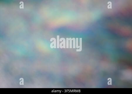 Soft focus iridescent background featuring colorful light leak and holographic bokeh effects. Ideal for artistic overlays. Stock Photo