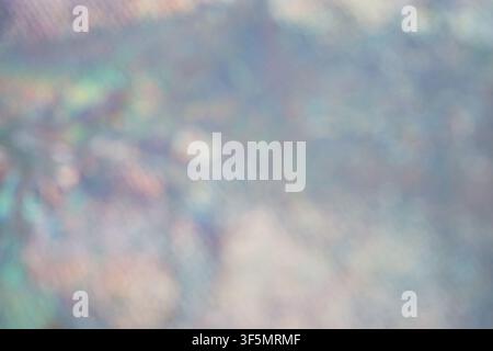 Soft out-of-focus iridescent background featuring pastel gradients and metallic bokeh effects for creative graphic design. Stock Photo