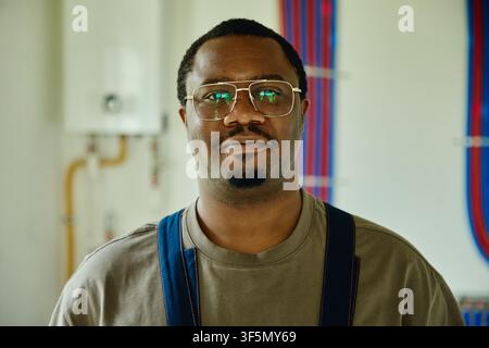 Portrait of Black Man Working on House Renovation and Heating System Stock Photo
