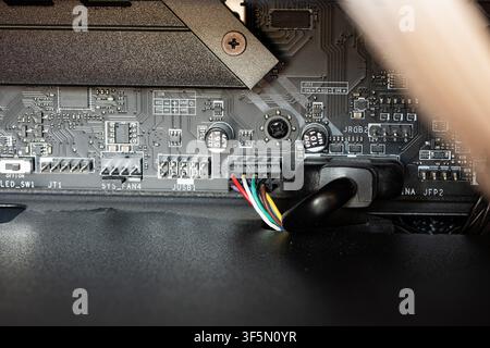 Urdorf, Switzerland, July 29,2026. Detailed close-up shot showing motherboard headers including USB connectors, system fan pins, RGB headers, and inte Stock Photo
