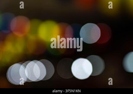 Colorful bokeh lights background, abstract defocused circles in white and warm tones, dreamy night texture backdrop Stock Photo
