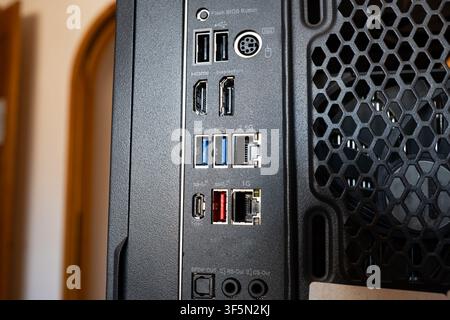 Close up view of the back rear panel connection ports of a custom PC computer case showing USB, Type-C, Ethernet, HDMI, DisplayPort, and audio connect Stock Photo