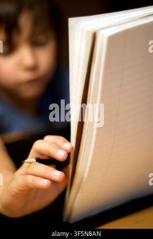 7-year old first grader doing his homework. Stock Photo
