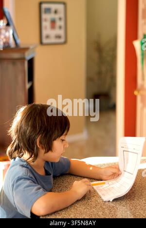 7-year old first grader doing his homework. Stock Photo