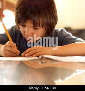 7-year old first grader doing his homework. Stock Photo