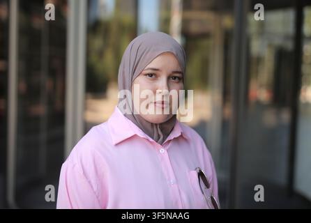 Confident young woman in hijab standing outdoors Stock Photo