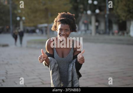 Happy young Black woman gives two thumbs up Stock Photo