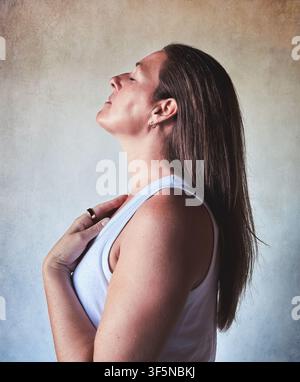 Serene woman breathing deeply with eyes closed Stock Photo
