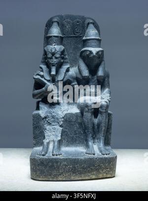 In Luxor museum, Egypt, a basalt statue of the seated Amenhotep III and falcon-headed god Horus embracing each other. Stock Photo