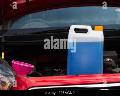 Windscreen wash fluid and funnel for auto car care Stock Photo