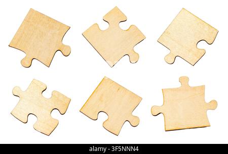 Wooden puzzle pieces lie disassembled, representing solutions and strategy Stock Photo