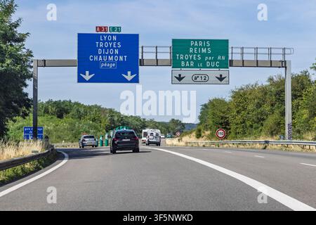 France - 24 July 2026: Split junction on highway A31 with blue and green direction signs leading towards Lyon and Exit 12 for Paris and Reims. Stock Photo