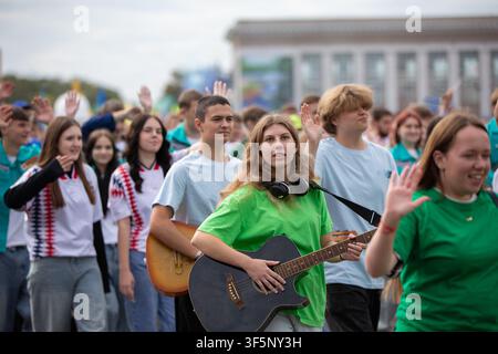 September 13, 2025. Belarus. Gomel. City Day celebration. Group of young people participating in a lively outdoor event, enjoying music and raising th Stock Photo
