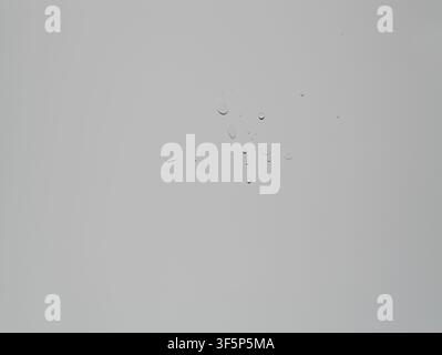 Water drops on a white surface. Water droplets on a white surface. Texture design. Stock Photo