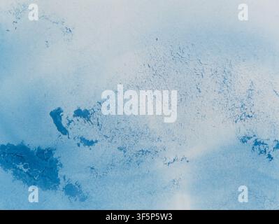 Abstract blue watercolor texture. Bright blue pigments spread naturally across the paper, creating a vibrant freeform pattern. Stock Photo