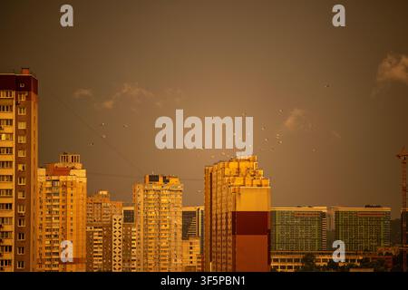 Pozniaky, Kyiv, Ukraine shows a sprawling residential district tall apartment towers and construction cranes under a dramatic dark sky filled with man Stock Photo