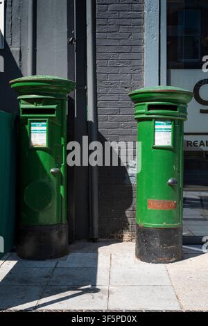 Two classic green post boxes in Cork city in Ireland Stock Photo
