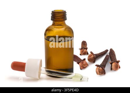 Clove essential oil in a glass dropper bottle with dried clove buds isolated on a white background. Natural herbal extract used for aromatherapy, well Stock Photo