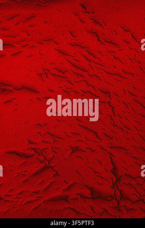 Cracked red faux leather texture background surface. Stock Photo