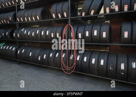 Inside Univesal Tire on Northern Boulevard in Queens with loads of tires, a hose and several different shapes. Stock Photo
