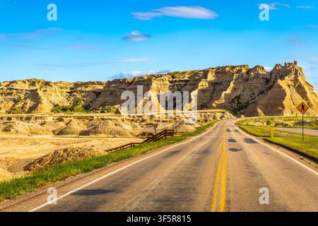 Winding scenic road cutting through dramatic eroded rock formations at Badlands National Park, South Dakota Stock Photo