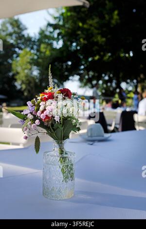 Outdoor event with flowers and coffee cups on the table Stock Photo