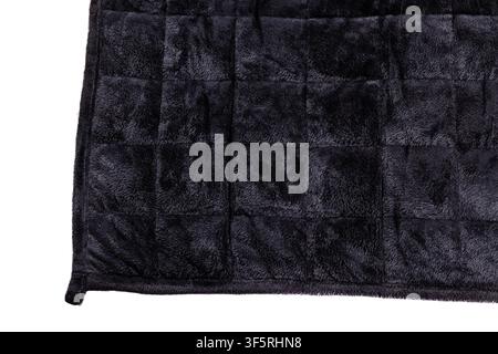 Close-up of a black weighted blanket featuring quilted stitching and soft plush fabric texture. Stock Photo