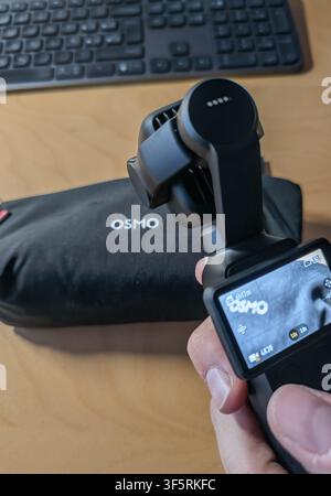 Barcelona, Spain. August 03, 2026, Hand holding DJI Osmo Pocket 4P or 4 pro gimbal camera Stock Photo
