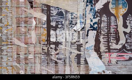 Torn Poster Layers, Weathered Paper Urban Texture. Layers of torn posters, weathered paper, abstract urban wall texture. Distressed surface, peeling Stock Photo