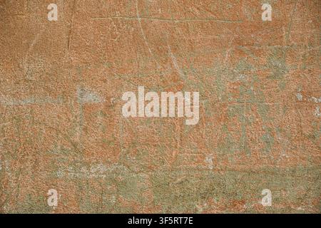 Weathered terracotta wall texture with subtle greenish patina, fine grain, scratches and uneven color variations, creating a warm rustic abstract back Stock Photo