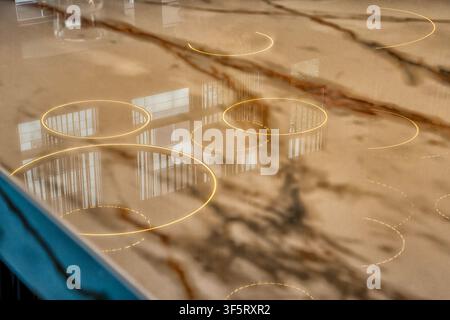 A glossy quartz or epoxy resin countertop featuring integrated circular lighting elements and a marble-like finish Stock Photo
