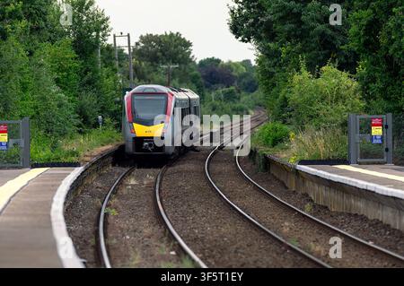 A diesel Train seen departing from Wroxham Station heading for Norwich on the Bittern Line, Norfolk, UK Stock Photo