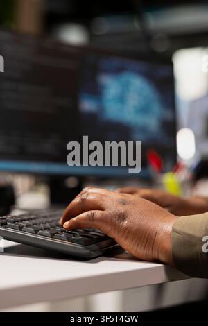 Close up of admin typing on PC keyboard, adjusting machine learning algorithms parameters at work to automate tasks. Tech startup worker writing AI code, doing optimizations Stock Photo