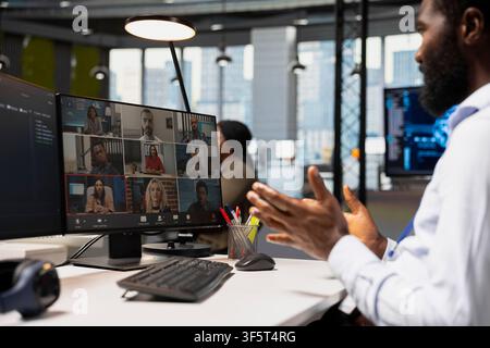 Developer doing internet videocall with team, adjusting deep learning algorithms parameters to automate tasks. Tech company employees in teleconference meeting discussing AI driven insights Stock Photo