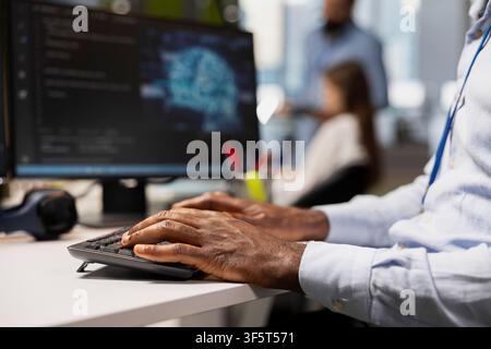 Close up of computer scientist writing code, developing neural networks APIs. Startup office worker troubleshooting application errors using AI technology on PC, typing on keyboard Stock Photo