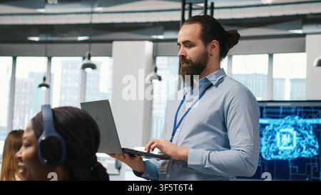 Team of programmers in office developing software applications, integrating AI driven automation in operations. Developers at work debugging applications to resolve issues, camera A Stock Photo