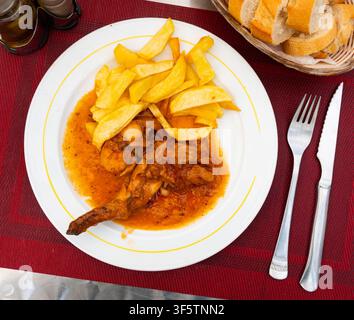 Braised rabbit served with potato garnish Stock Photo