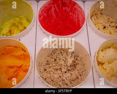 Overhead view of six colorful tubs of ice cream and gelato in various delicious flavors Stock Photo