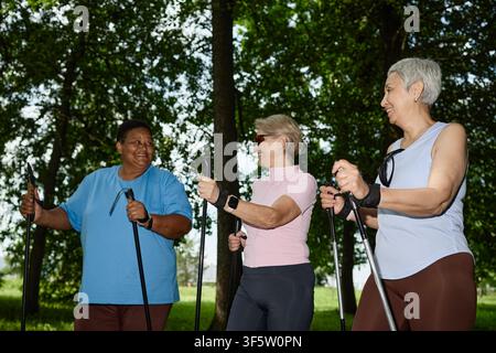 Diverse Senior Women Enjoying Nordic Walking in Park for Active Aging Stock Photo